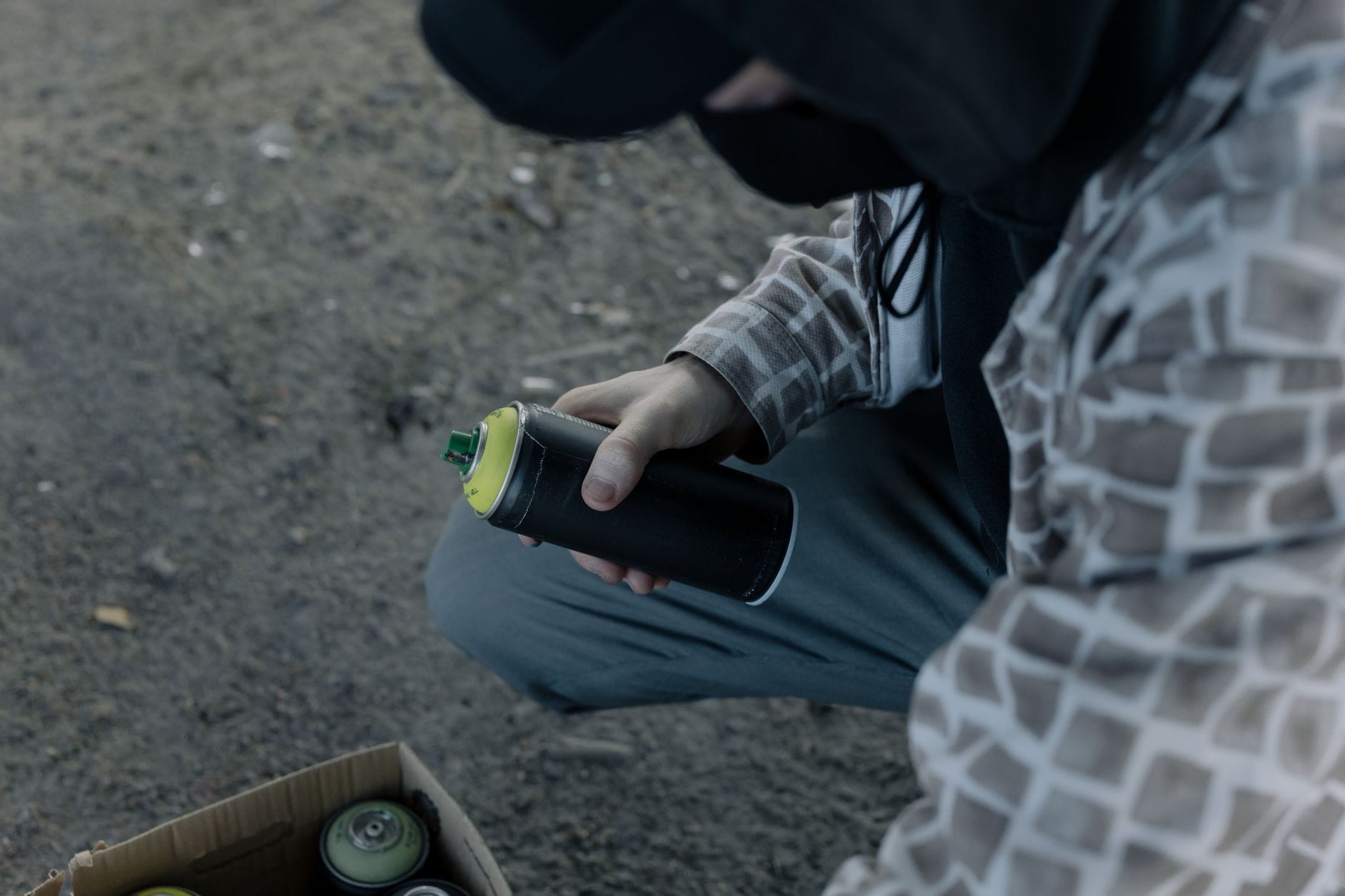 Artysta z puszką farby w sprayu przygotowuje się do malowania graffiti
